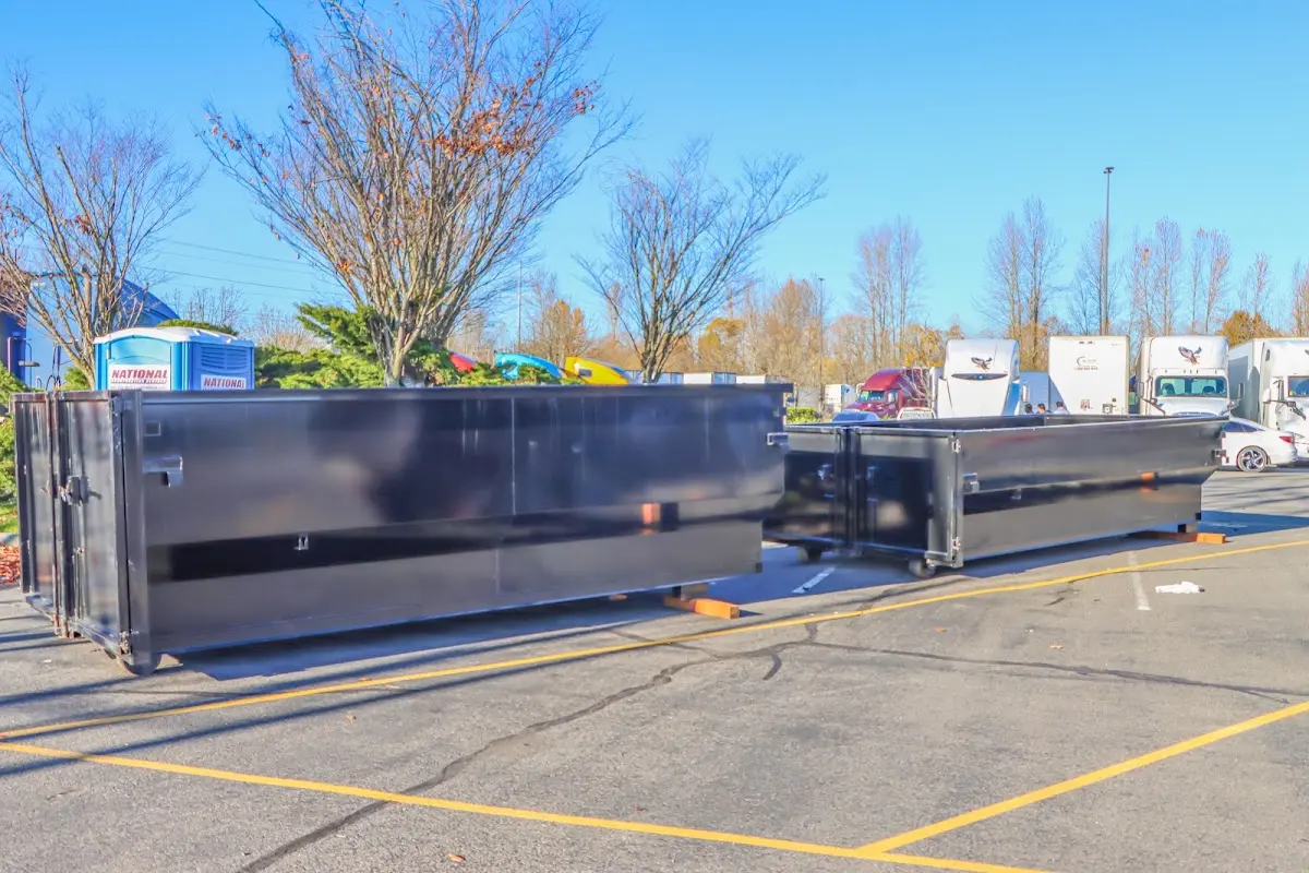 Professional dumpster rental service with roll-off container on residential driveway in Burbank